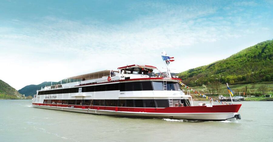 Vienna: Heurigen Cruise with Viennese Songs and Buffet - Historic buildings along the water